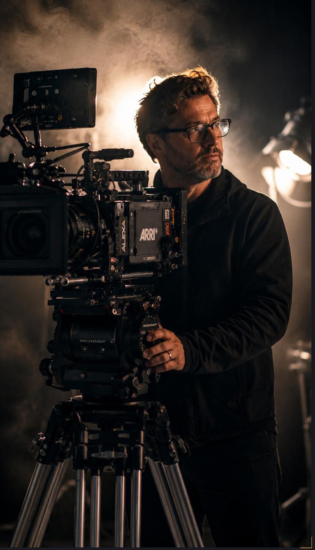 Cinematographer operating an ARRI camera on set