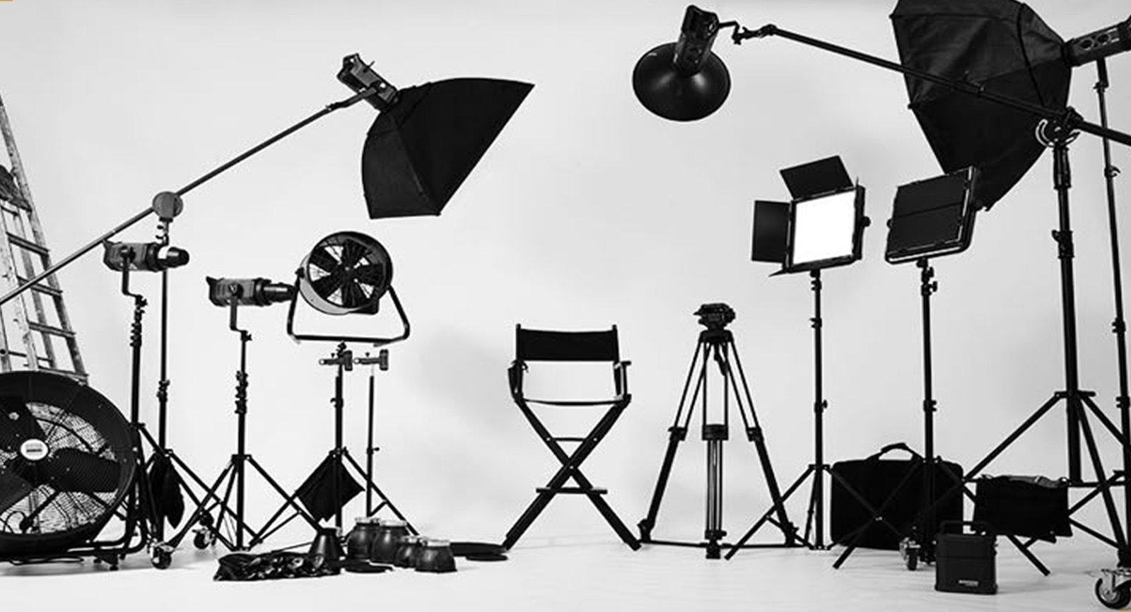 Studio lighting and camera equipment on a white cyclorama