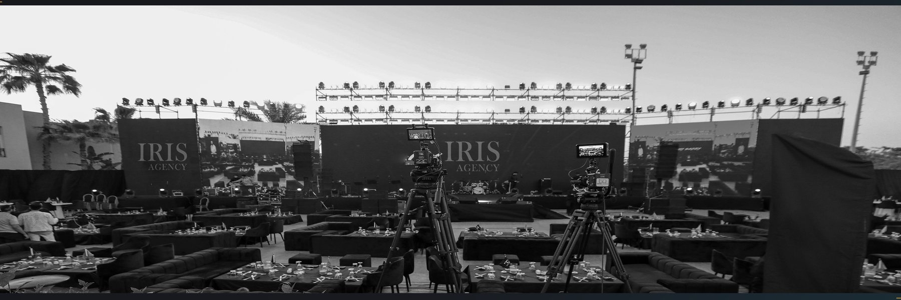 Outdoor event stage with cameras and IRIS Agency branding