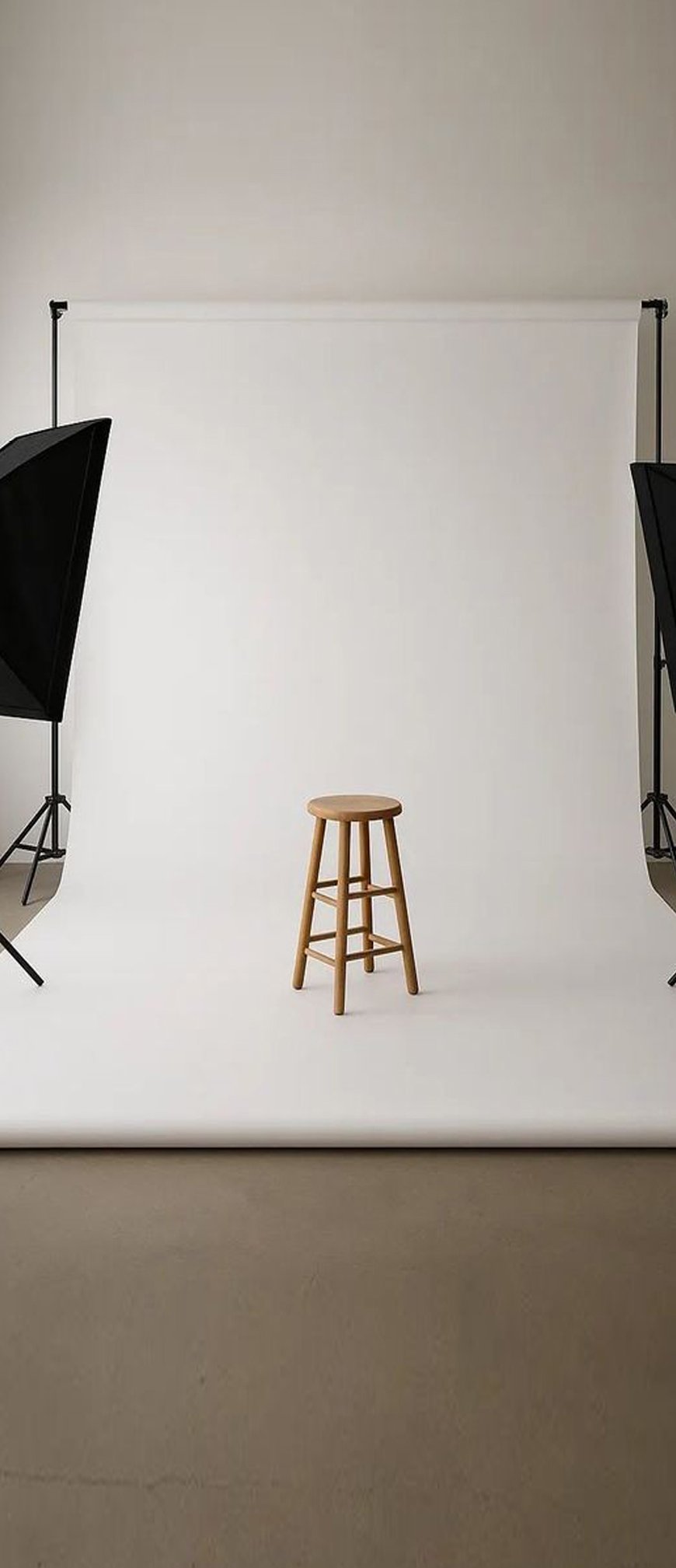 White cyclorama studio with wooden stool